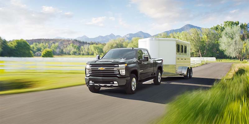 2024 Chevrolet Silverado 2500 towing a white trailer